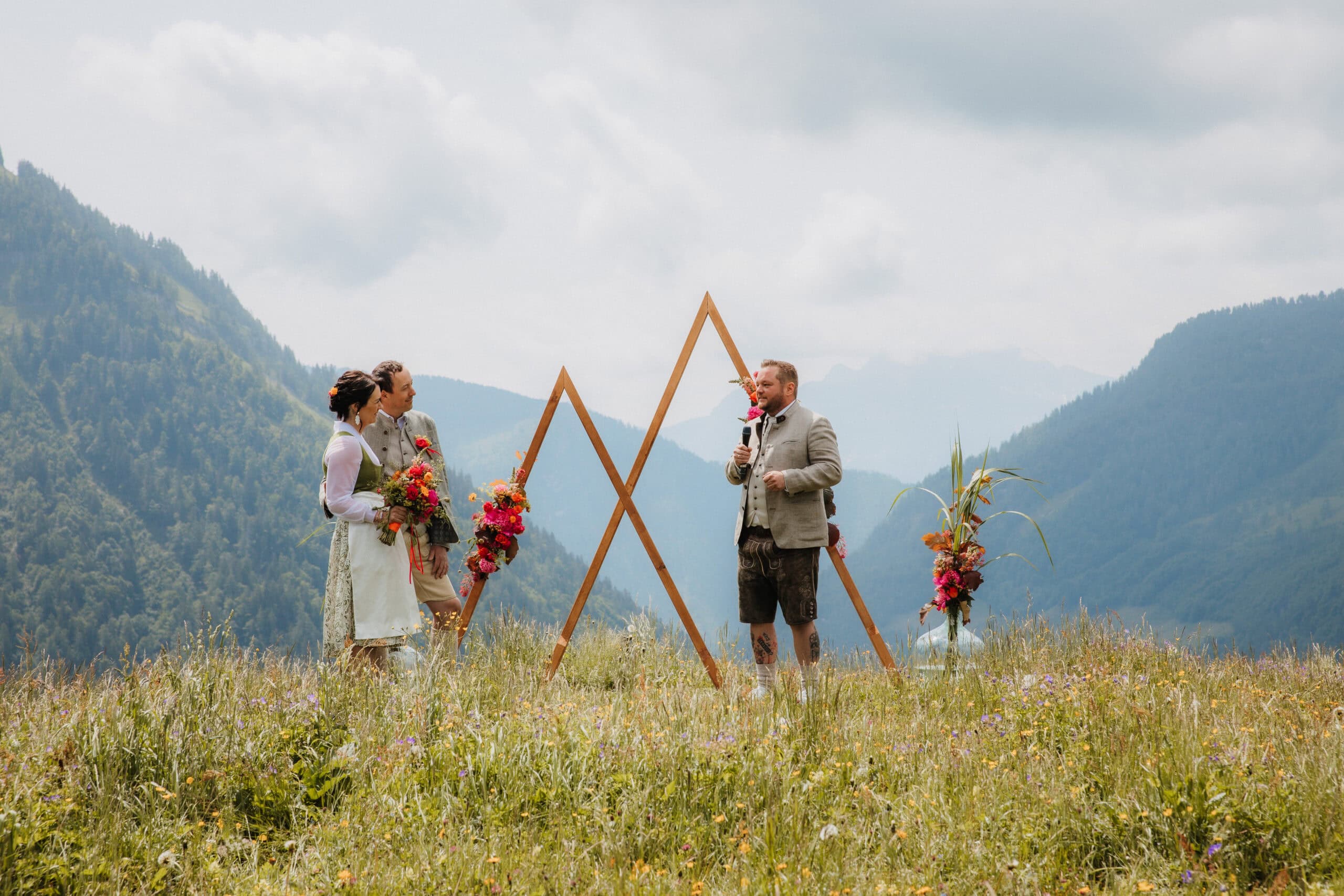 Trauredner Tom Salzlechner hält auf einem Berg eine Freie Trauung für sein Hochzeitspaar ab